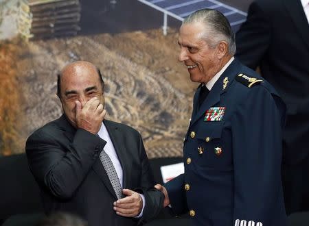 Mexico's attorney general Jesus Murillo Karam (L) and Mexico's Defense Minister General Salvador Cienfuegos share a smile during a meeting at the National Palace in Mexico City August 11, 2014. REUTERS/Edgard Garrido