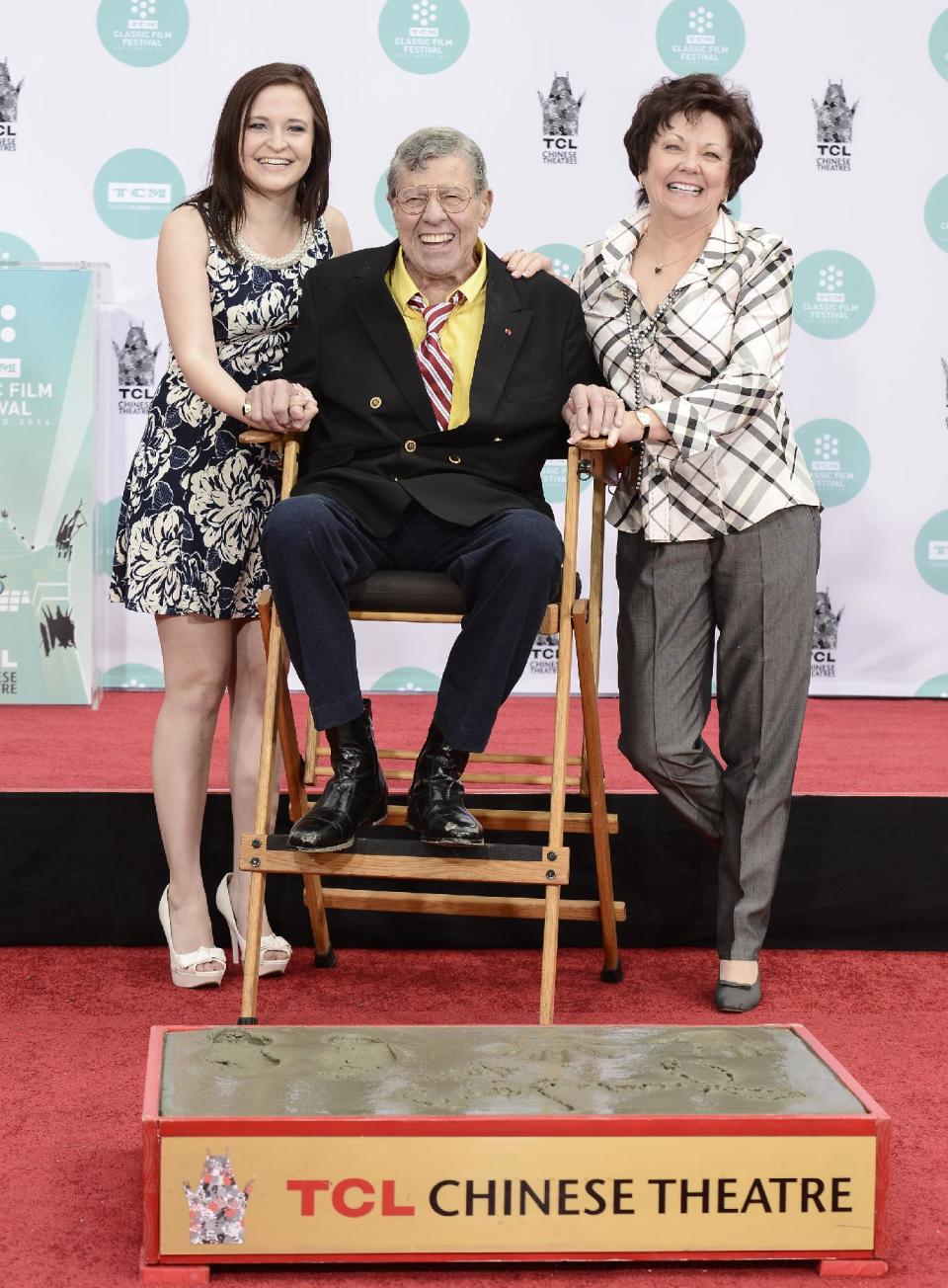 Actor and comedian Jerry Lewis, center, his wife, SanDee Pitnick, right, and his daughter Danielle Lewis pose together as he is honored with a hand and footprint ceremony at TCL Chinese Theatre on Saturday, April 12, 2014 in Los Angeles. (Photo by Dan Steinberg/Invision/AP Images)