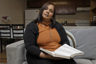 In this Wednesday, Feb. 26, 2020 photo, Yarelis Gutierrez Barrios poses for a photo at her home in Tampa, Fla. Her partner Roylan Hernandez Diaz, a Cuban asylum seeker, hanged himself in a Louisiana prison last October. An Associated Press investigation into Hernandez’s death found neglect and apparent violations of government policies by jailers under U.S. Immigration and Customs Enforcement. (AP Photo/Chris O'Meara)