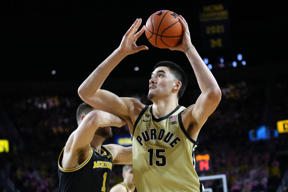 Purdue center Zach Edey (15) drives to the basket past Michigan center Hunter Dickinson (1) during the first half of an NCAA college basketball game in Ann Arbor, Mich., Thursday, Jan. 26, 2023. (AP Photo/Paul Sancya)