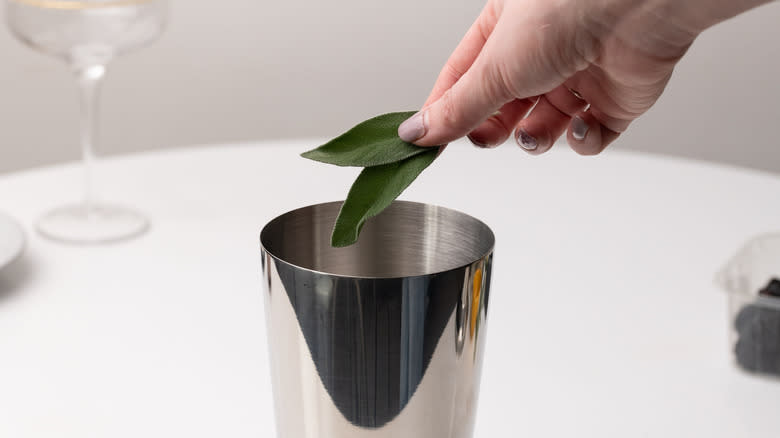 adding sage to cocktail shaker 