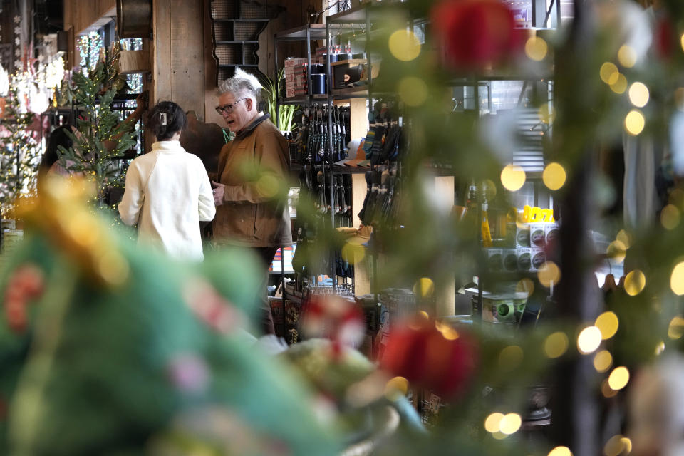 Rick Haase, owner of eight Patina gift shops, talks with merchandise director Kamie Hoover, Thursday, Nov. 2, 2023, in Woodbury, Minn. All signs point to a relatively solid holiday season for America’s small businesses. Yet, owners of these businesses appear to have a collective anxiety about the months ahead. (AP Photo/Abbie Parr)