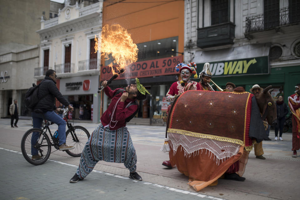 A member of the Brazilian theater group Clowns of Shakespeare spits fire during a performance in Bogota, Colombia, Saturday, Oct. 26, 2019. The troupe's play titled “Abrazo,” or Hug, is among the growing list of shows, plays, conferences and other artistic projects that have been abruptly canceled in Brazil since the nation's President Jair Bolsonaro took office Jan. 1, after the troupe talked politics with the audience during the show’s debut. (AP Photo/Ivan Valencia)