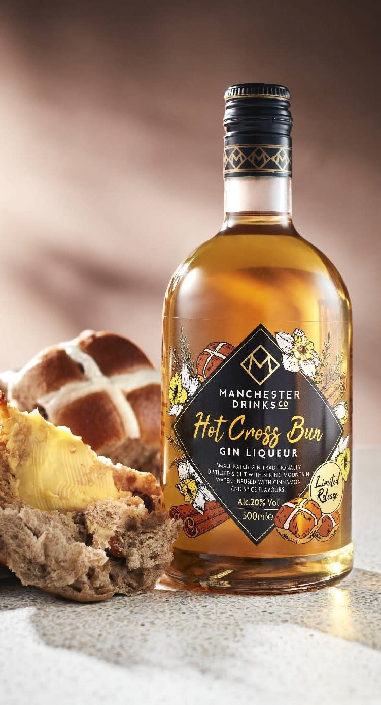 Aldi's hot cross bun flavoured gin bottle next to a hot cross bun