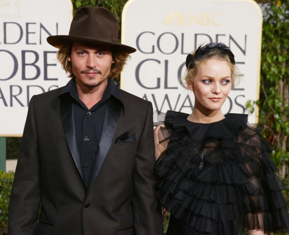 Johnny Depp (L) and Girlfriend Vanessa Paradis attend the 61st Annual Golden Globe Awards at the Beverly Hilton Hotel on January 25, 2004 in Beverly Hills, California