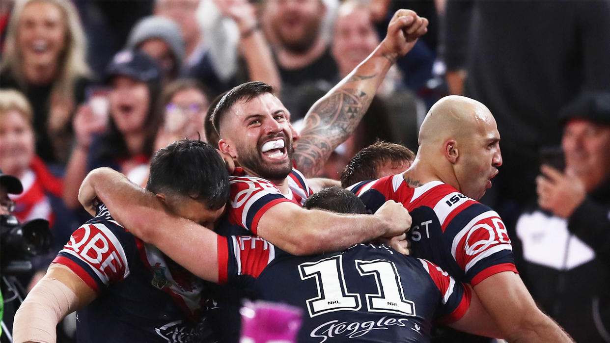 James Tedesco celebrating with teammates after scoring a try.