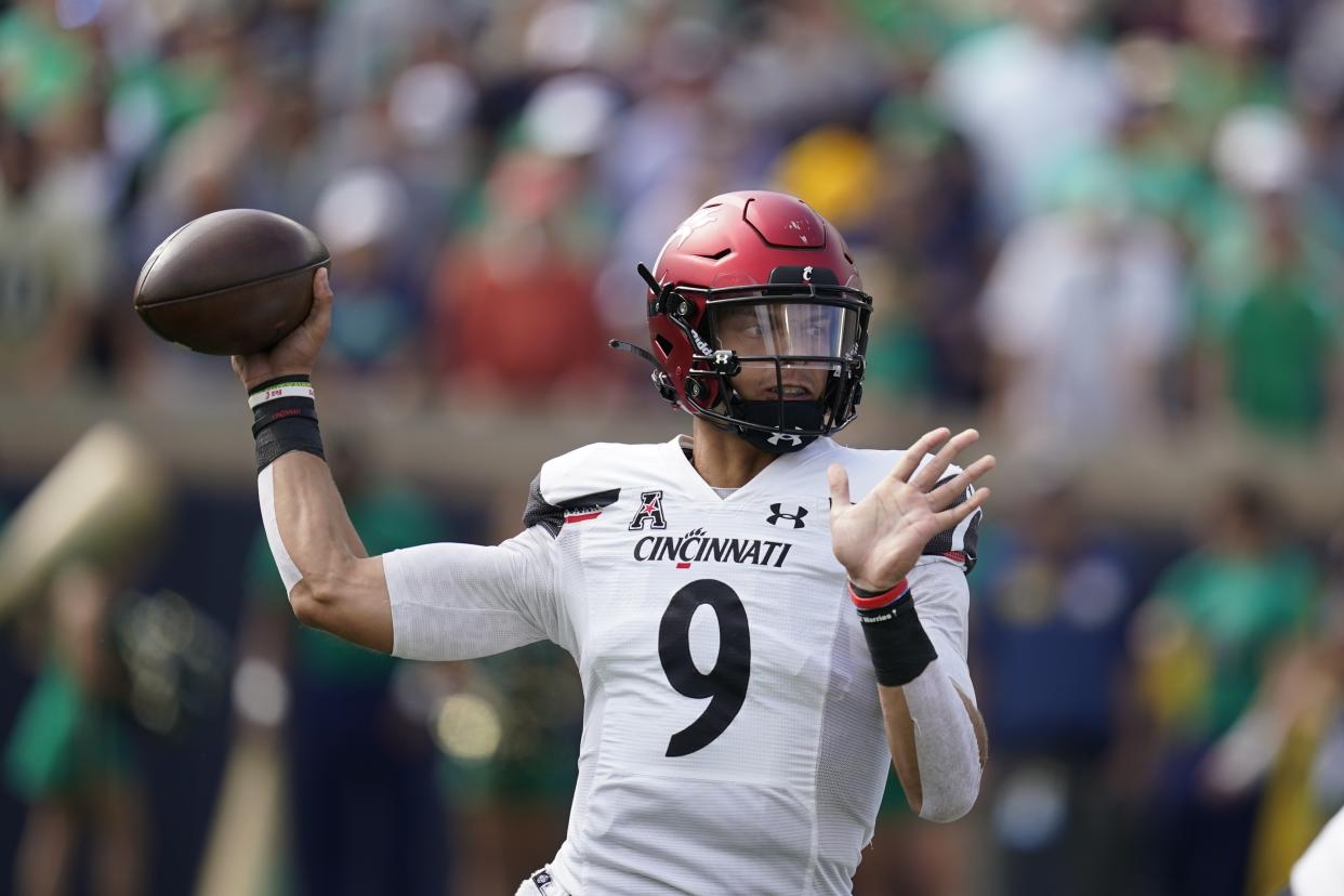 Cincinnati quarterback Desmond Ridder (9) throws during the first half of an NCAA college football game against Notre Dame, Saturday, Oct. 2, 2021, in South Bend, Ind. (AP Photo/Darron Cummings)