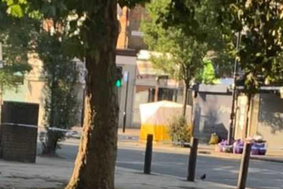 A forensic tent has been erected by a bus stop on Green Lanes  (Amanda Diment)