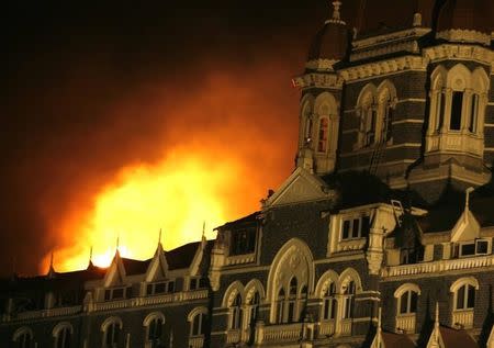 Smoke and fire billows out of the Taj Hotel in Mumbai November 27, 2008. REUTERS/Jayanta Shaw