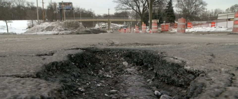 a massive pothole in snowy milwaukee