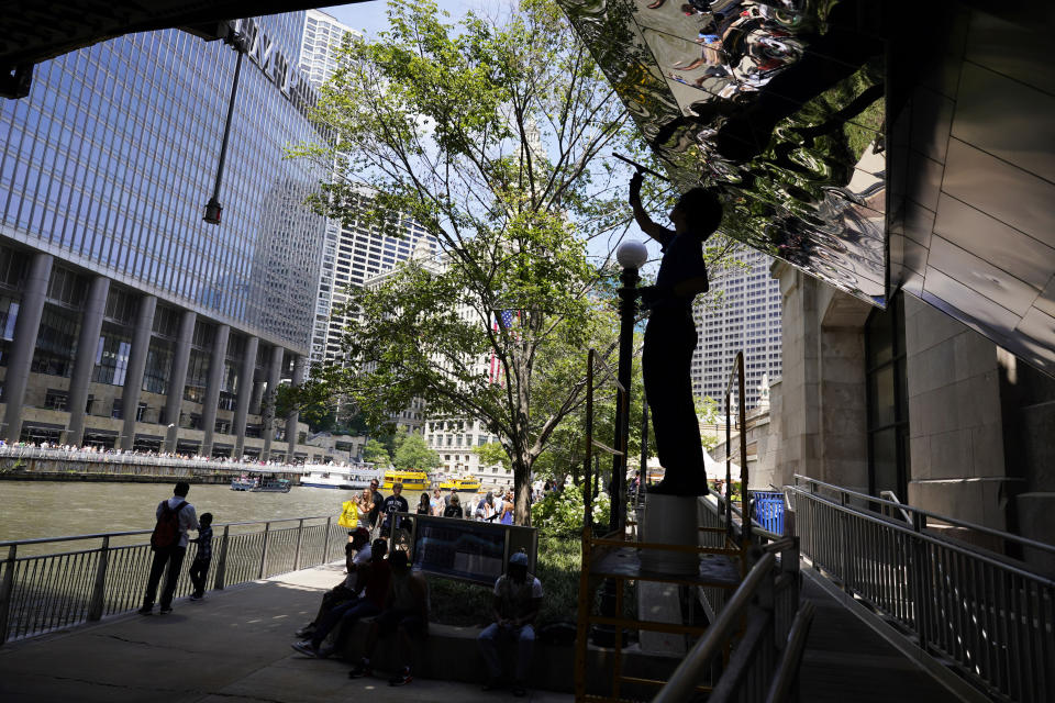 People walk along the Chicago Riverwalk in Chicago, Monday, July 3, 2023, a day after heavy rains flooded Chicago streets and neighborhoods. (AP Photo/Nam Y. Huh)