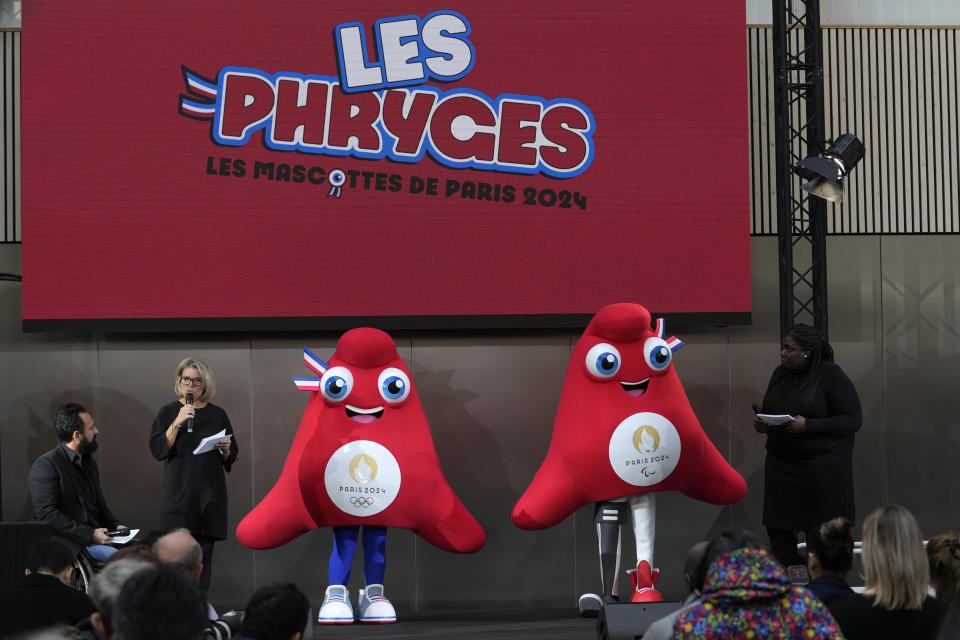 The mascots of the 2024 Paris Olympic Games, left, and Paralympic Games are presented Monday, Nov. 14, 2022 in Saint-Denis, outside Paris. The mascot, a Phrygian cap, also known as a liberty cap, is an updated version of a conical hat worn in antiquity in places such as Persia, the Balkans, Thrace, Dacia and Phrygia, where the name originates, in modern day Turkey. It later became a symbol of the pursuit of liberty in the French Revolution, and is still worn by the figure of Marianne, the national personification of France since that time. (AP Photo/Thibault Camus)