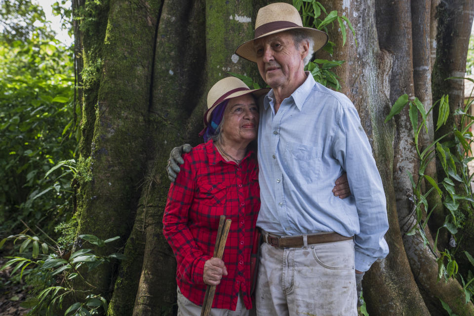 Floripe Cordoba, left, and Siegfried Kussmaul pose for photos at their protected forest on the outskirts of San Jose, Costa Rica, Wednesday, Aug. 24, 2022. Cordoba and Kussmaul decided years ago that they wanted to let the forest retake the 8 acres near San Jose where they had grown coffee and raised cattle, though they said some neighbors thought they were “crazy.” (AP Photo/Moises Castillo)