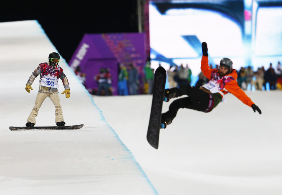 Shaun White of the United States waits on the edge of the half pipe during a snowboard half pipe training session at the Rosa Khutor Extreme Park at the 2014 Winter Olympics, Monday, Feb. 10, 2014, in Krasnaya Polyana, Russia. (AP Photo/Sergei Grits)