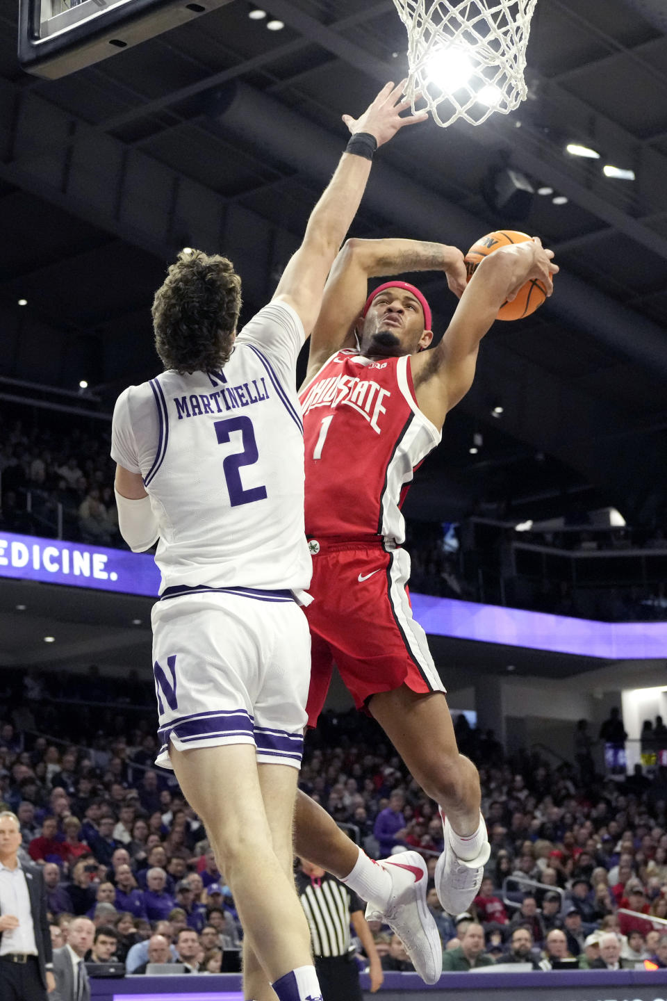 Ohio State guard Roddy Gayle Jr., right, goes up for a dunk against Northwestern forward Nick Martinelli (2) during the first half of an NCAA college basketball game in Evanston, Ill., Saturday, Jan. 27, 2024. (AP Photo/Nam Y. Huh)