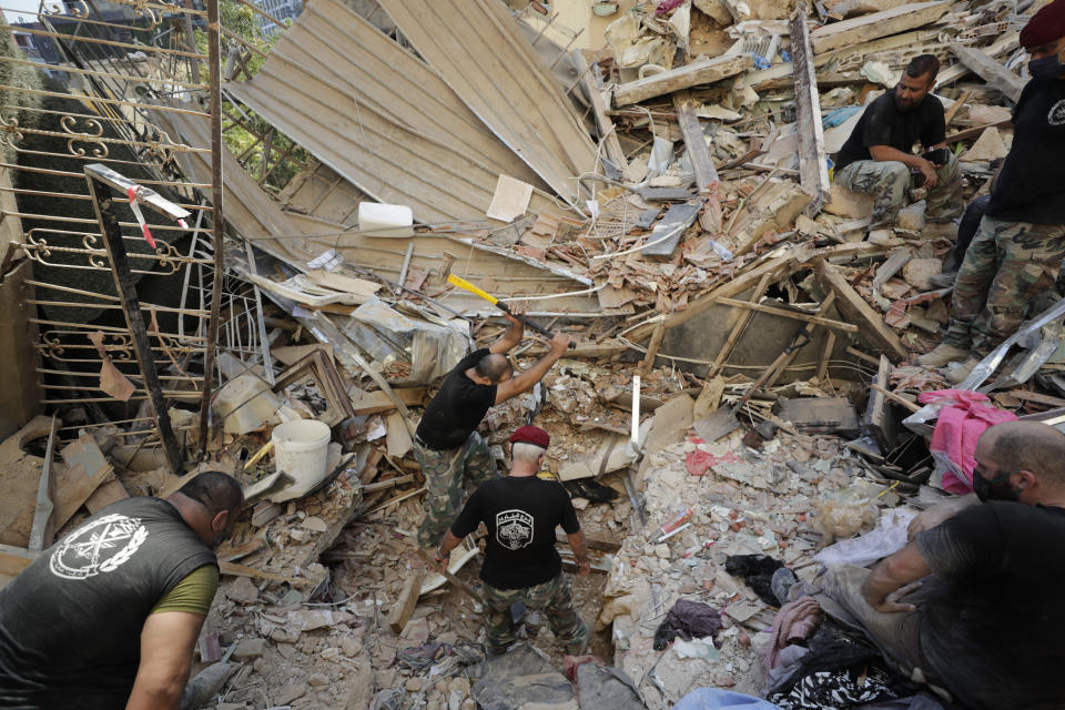 Lebanese soldiers search for survivors after a massive explosion in Beirut, Lebanon, Wednesday, Aug. 5, 2020. The explosion flattened much of a port and damaged buildings across Beirut, sending a giant mushroom cloud into the sky. In addition to those who died, more than 3,000 other people were injured, with bodies buried in the rubble, officials said.(AP Photo/Hassan Ammar)