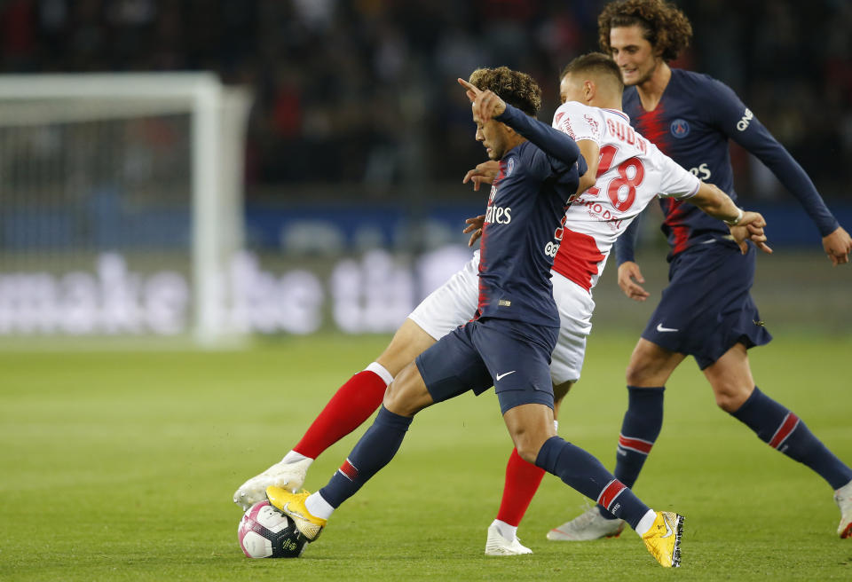 FILE - In this Sept. 26, 20-19 file picture PSG's Neymar, left, fights for the ball with Reims' Remi Oudin during the French League One soccer match between Paris-Saint-Germain and Reims at the Parc des Princes stadium in Paris, France. Fifth-placed Reims's excellent run in the French league is largely due to the performances of 22-year-old Remi Oudin, a versatile attacking midfielder with an impressive left foot and a great touch. (AP Photo/Michel Euler, File)