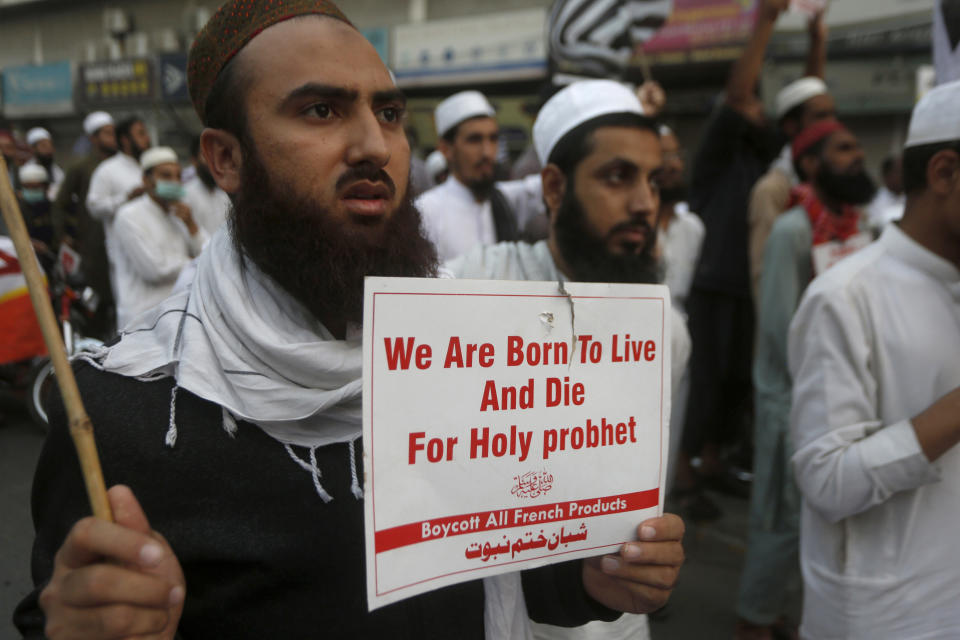 Supporters of the religious group, Sunhan Khatam-e-Nabuwat, hold a rally denouncing French President French President Emmanuel Macron and the republishing in France of caricatures of the Prophet Muhammad they deem blasphemous, in Lahore, Pakistan, Sunday, Nov. 8, 2020. (AP Photo/K.M. Chaudary)