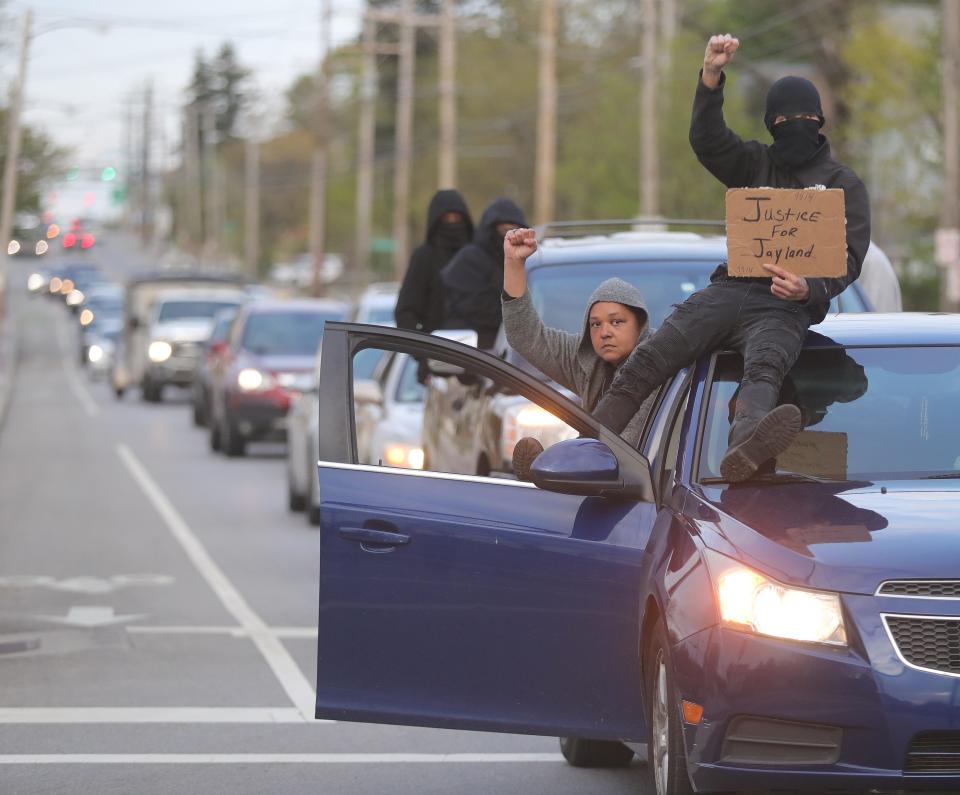 Jayland Walker protesters follow a march down East Tallmadge Avenue on Monday, April 24, 2023, in Akron.