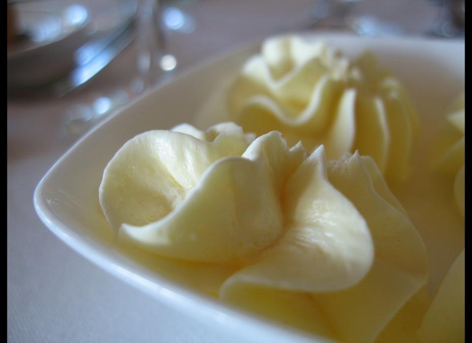 The process of whipping adds air to the butter, making it lighter and less dense. If you can stick with the same tablespoon-size portion, you'll save up to half the calories and saturated fat by choosing whipped butter in a tub.     Land O'Lakes Whipped Butter, for example, contains 50 calories and 6 grams of fat (3.5 grams saturated), and only 15 milligrams of cholesterol per serving.     You can also choose an organic brand like Organic Valley Whipped Butter.  