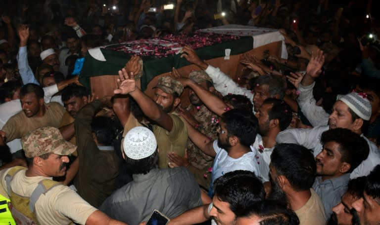 Pakistani military officials, relatives and residents of Faisalabad carry the coffin of a soldier killed in firing along the Line of Control in Kashmir on September 29, 2016