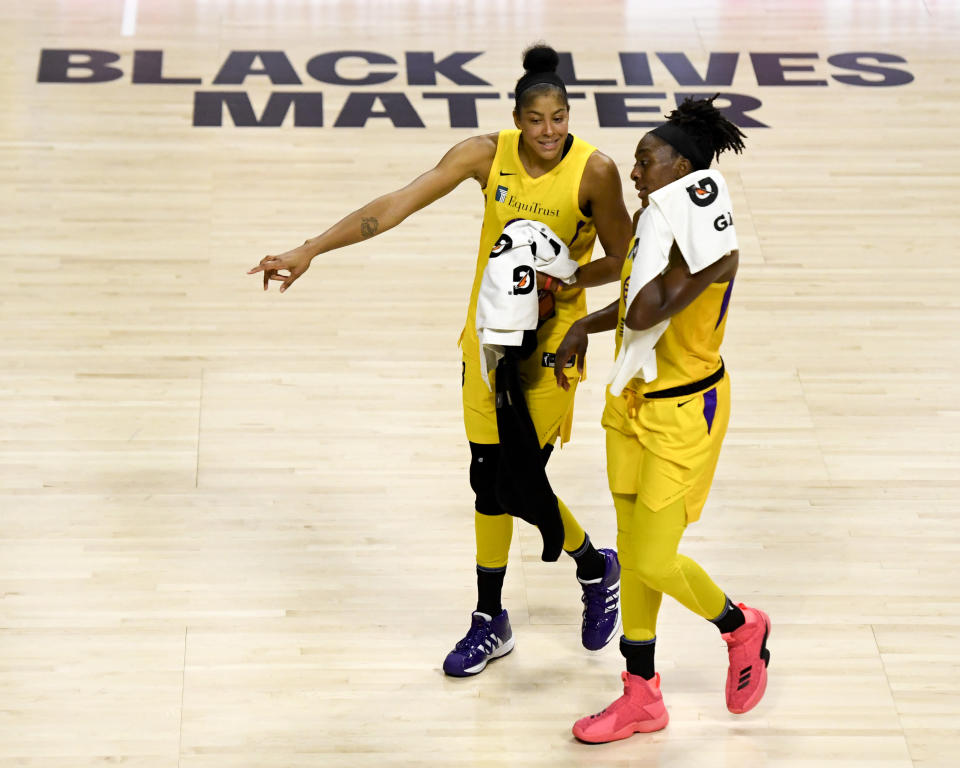 Candace Parker and Nneka Ogwumike walk off the court. 