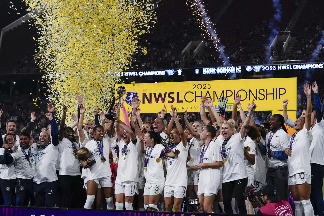 NJ/NY Gotham defender Ali Krieger (11) holds the trophy after NJ/NY Gotham defeated OL Reign 2-1 in the NWSL Championship soccer game, Saturday, Nov. 11, 2023, in San Diego. (AP Photo/Gregory Bull)
