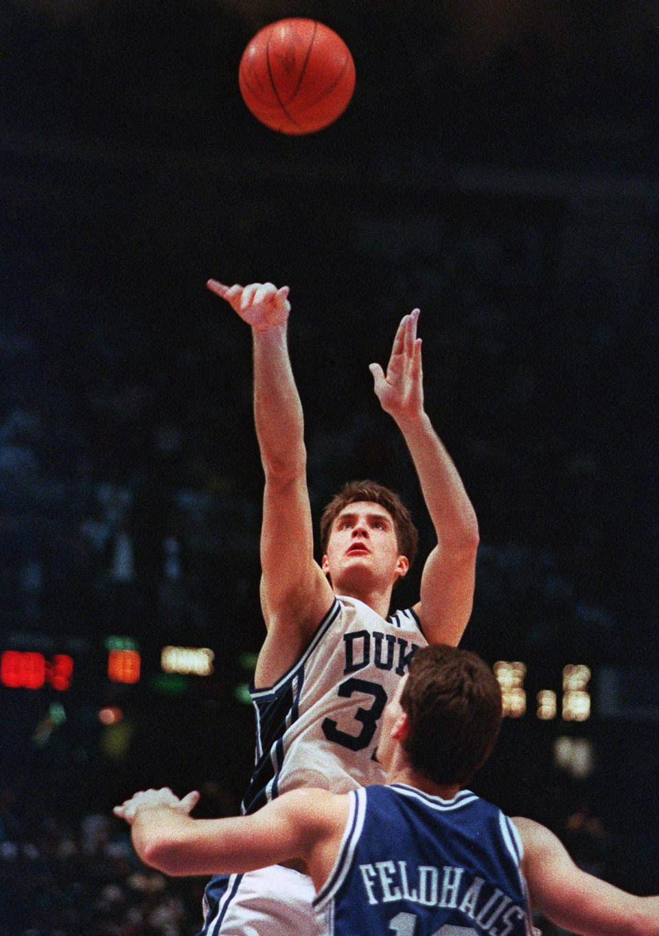 FILE - In this March 28, 1992, file photo, Duke's Christian Laettner takes the winning shot in overtime over Kentucky's Deron Feldhaus for a 104-103 victory in the East Regional final NCAA college basketball game in Philadelphia. (AP Photo/Charles Arbogast, File)
