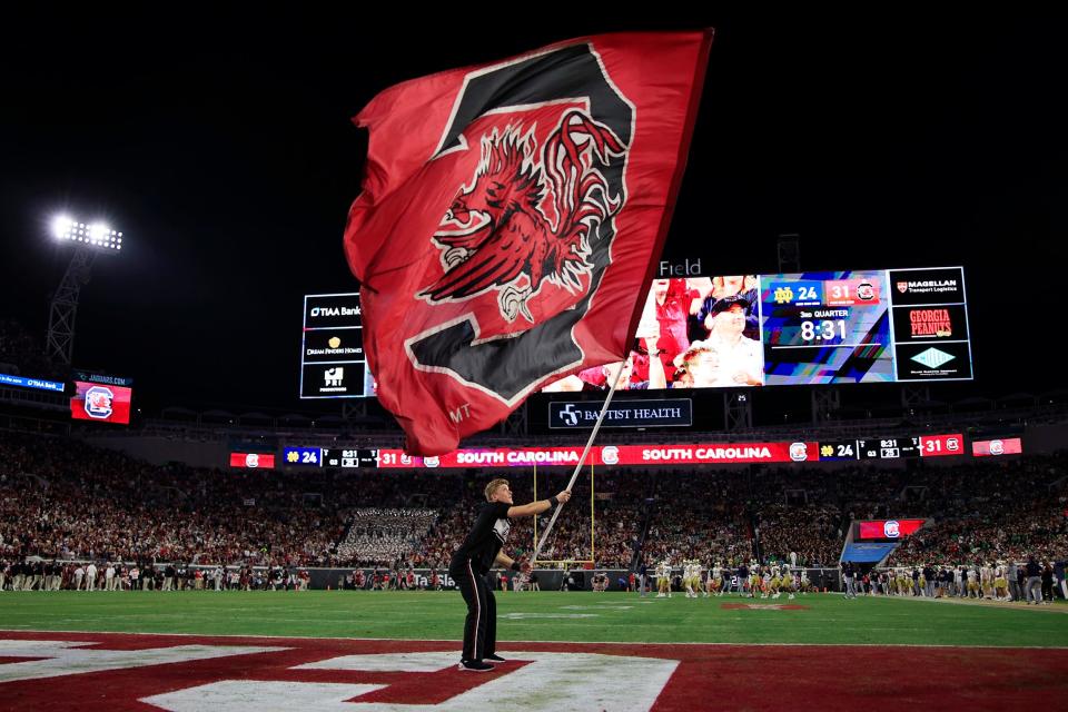A South Carolina Gamecocks cheerleader waves the flag after a score during the third quarter of the TaxSlayer Gator Bowl on Dec. 30 at TIAA Bank Field.