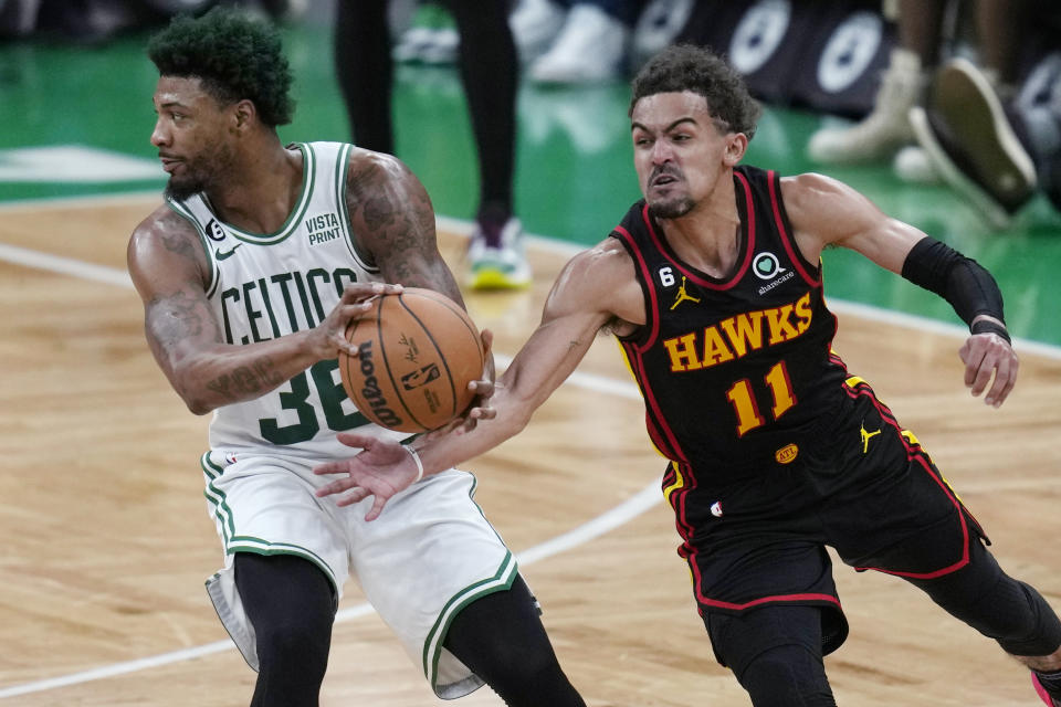 Atlanta Hawks guard Trae Young (11) tries to steal the ball from Boston Celtics guard Marcus Smart (36) during the second half of Game 2 in the first round of the NBA basketball playoffs, Tuesday, April 18, 2023, in Boston. (AP Photo/Charles Krupa)