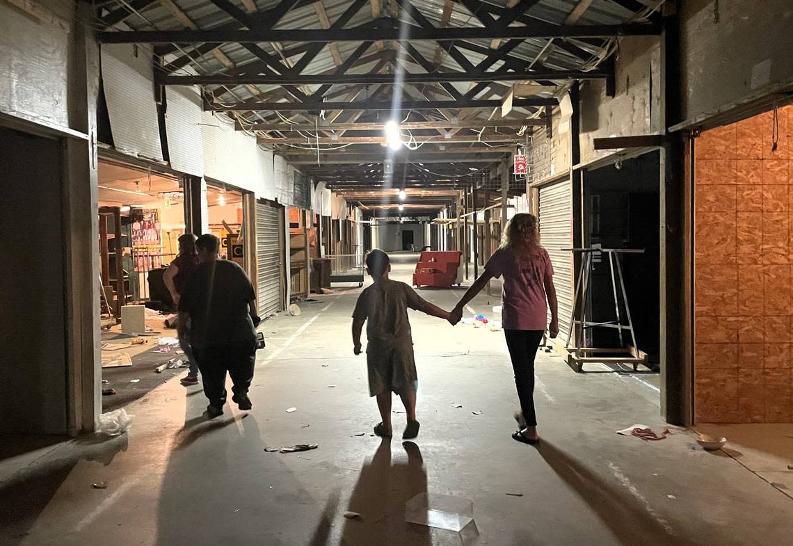 A group of cat rescue volunteers scouts out the vacated stalls at the now-closed Buckhorn Jockey Lot and Flea Market on Aug. 16, 2024. They have saved over a dozen cats, including a pregnant female, who are about to lose their home to redevelopment.