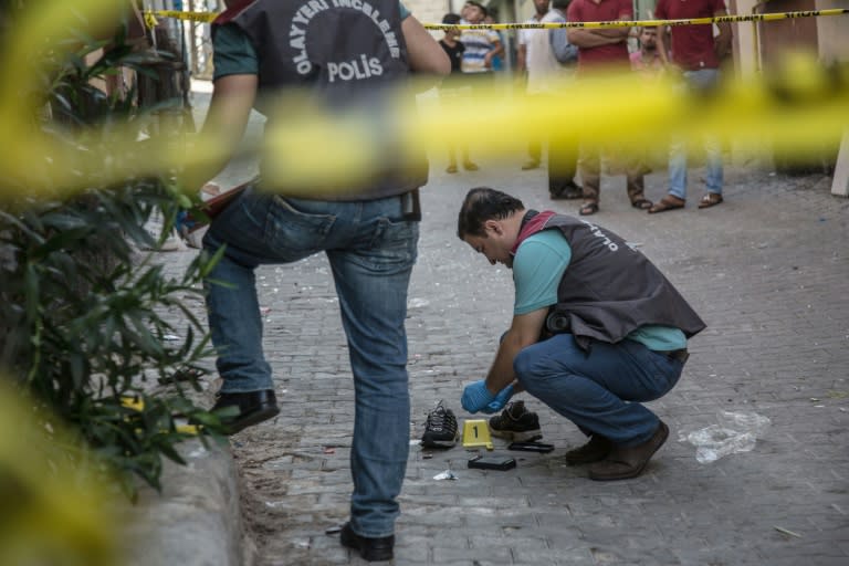 Turkish police work near the explosion scene following a late night attack on a wedding party that left at least 51 dead in Gaziantep in southeastern Turkey near the Syrian border on August 21, 2016