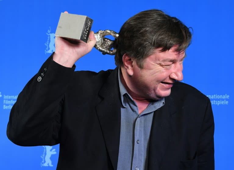 Finnish director and screenwriter Aki Kaurismaki poses with his Silver Bear for Best Director prize for his movie "The Other Side of Hope" after the Award Ceremony of the 67th Berlinale film festival in Berlin on February 18, 2017