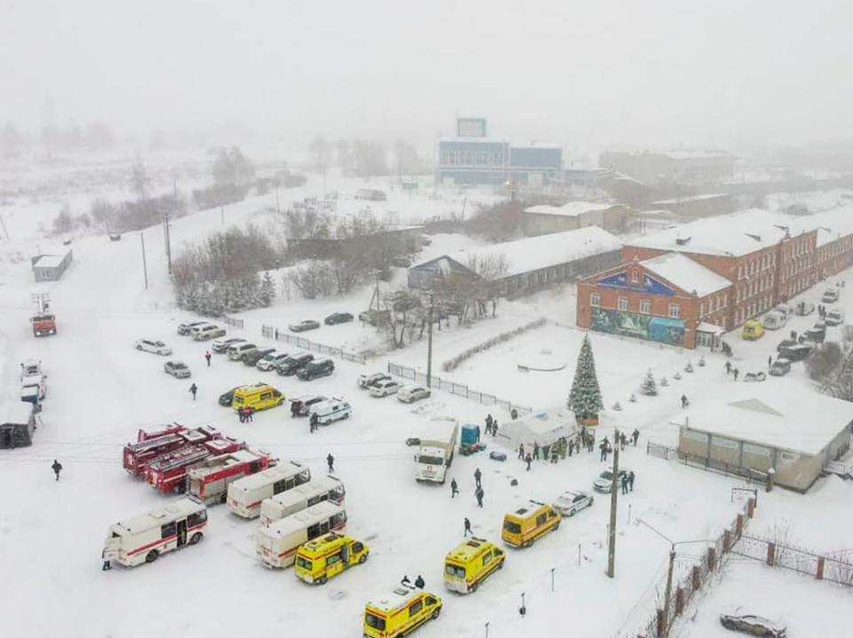 Ambulances and fire trucks are parked near the Listvyazhnaya coal mine (AP)