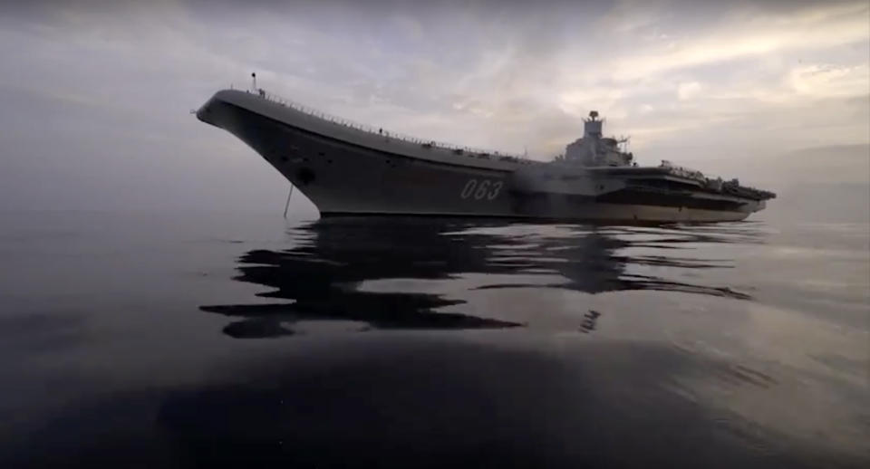 In this photo made from the footage taken from the Russian Defense Ministry official web site on Wednesday, Jan. 4, 2017, the Admiral Kuznetsov aircraft carrier is on a mission in the eastern Mediterranean Sea. (Russian Defense Ministry Press Service/ Photo via AP)