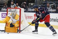 Nashville Predators' Juuse Saros, left, makes a save against Columbus Blue Jackets' Seth Jones during the second period of an NHL hockey game Monday, May 3, 2021, in Columbus, Ohio. (AP Photo/Jay LaPrete)