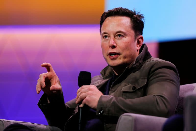 FILE PHOTO: Tesla CEO Elon Musk gestures during a conversation at the E3 gaming convention in Los Angeles