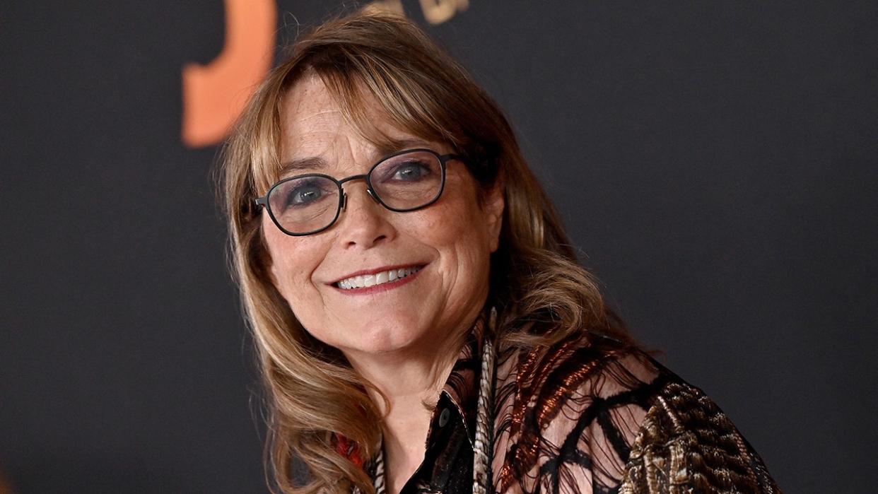 A close-up of Karen Allen wearing glasses