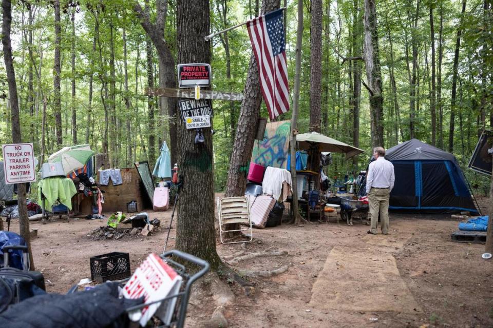 Business owner, Paul Bradley, brings law enforcement and code enforcement to the homeless encampment on his commercial property in Charlotte, N.C., on Wednesday, September 20, 2023. Paul Bradley is in a dispute with code enforcement over him allowing homeless people to camp on his commercial property