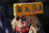 A supporter waits for President Donald Trump to speak at a campaign rally Friday, Oct. 30, 2020, at the Austin Straubel Airport in Green Bay, Wis. (AP Photo/Morry Gash)