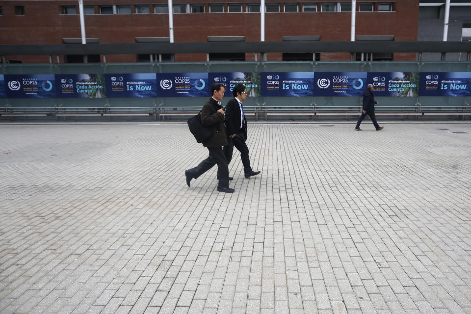 Participants walk ahead of the Climate Summit COP25 in Madrid, Spain, Friday, Nov. 29, 2019. The Climate Summit COP25 runs between 2 Dec. until 13 Dec in Madrid. (AP Photo/Manu Fernandez)