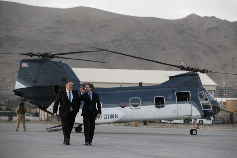 Secretary of State Mike Pompeo, left, walks from a helicopter with U.S. Ambassador to Afghanistan John Bass, Tuesday, June 25, 2019, as Pompeo returns to his plane after an unannounced visit to Kabul, Afghanistan. (AP Photo/Jacquelyn Martin, Pool)