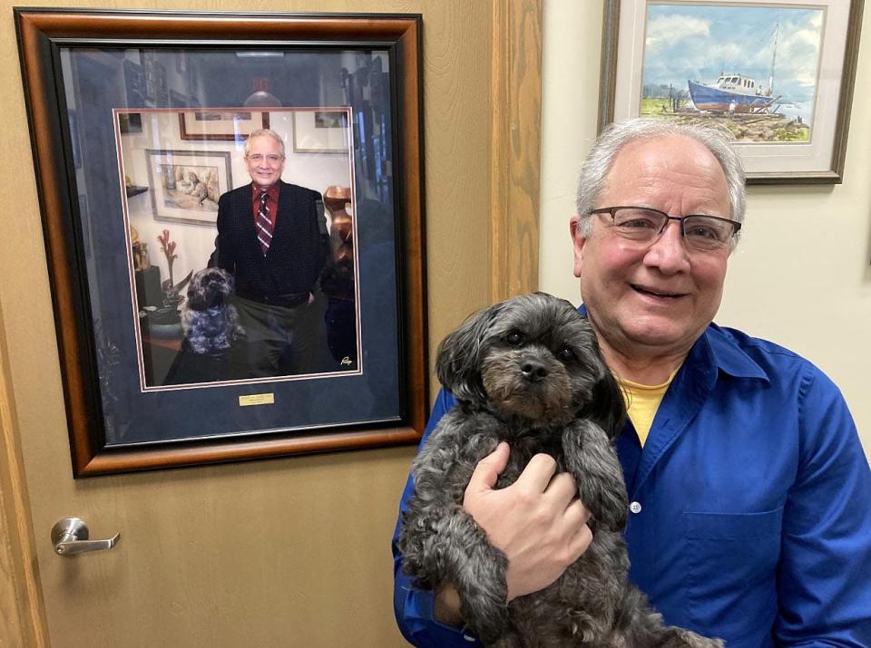 Dr. Frank Tursi, shown in his LECOM Health office with his 16-year-old dog Magilla, has been a family physician in Erie since 1982.