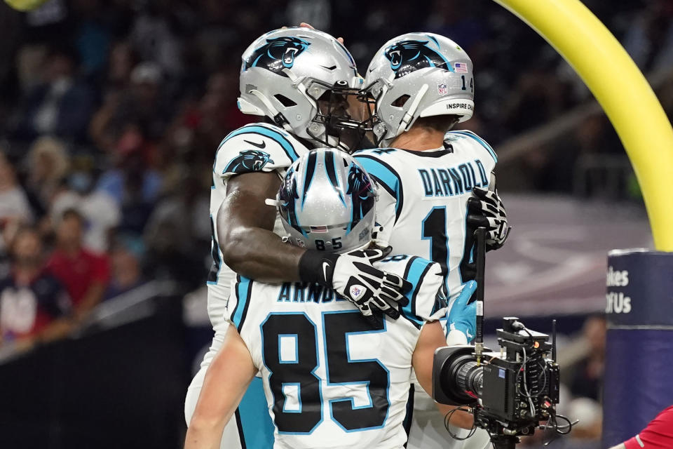 Carolina Panthers quarterback Sam Darnold (14) celebrates his touchdown run with Dan Arnold (85) and Cameron Erving (75) during the first half of an NFL football game Thursday, Sept. 23, 2021, in Houston. (AP Photo/Eric Christian Smith)