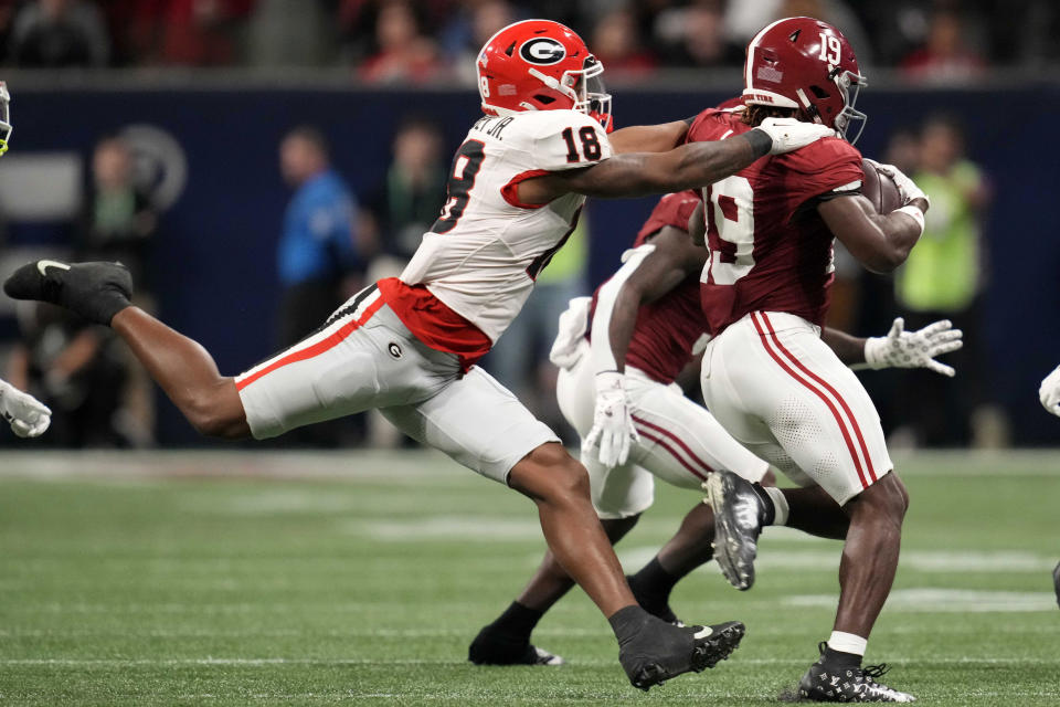 Dec 2, 2023; Atlanta, GA, USA; Georgia Bulldogs linebacker Xavian Sorey Jr. (18) makes a tackle on Alabama Crimson Tide wide receiver Kendrick Law (19) during the second half in the SEC Championship game at Mercedes-Benz Stadium. Mandatory Credit: Dale Zanine-USA TODAY Sports