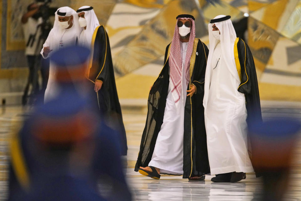 Emirati National Security Adviser Sheikh Tahnoon bin Zayed Al Nahyan, center, arrives ahead of a visit by Turkish President Recep Tayyip Erdogan, at Qasr Al-Watan, in Abu Dhabi, United Arab Emirates, Monday, Feb. 14, 2022. Erdogan traveled Monday to the United Arab Emirates, a trip signaling a further thaw in relations strained over the two nations' approaches to Islamists in the wake of the 2011 Arab Spring. (AP Photo/Jon Gambrell)