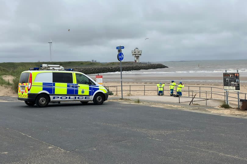 The coastguard watch the coastline with binoculars on Crosby beach