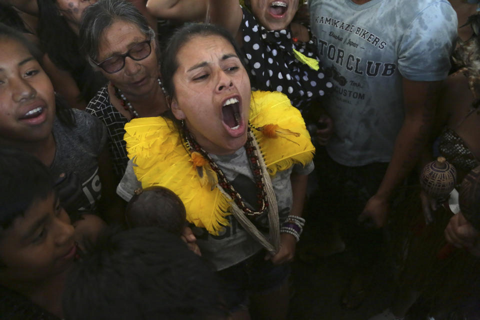 Indigenous woman celebrate after a majority of Supreme Court justices ruled to enshrine their land rights in a landmark case in Brasilia, Brazil, Thursday, Sept. 21, 2023. Six of the 11 Supreme Court justices voted against establishing a cut-off date after which Indigenous peoples could not claim new territory. (AP Photo/Gustavo Moreno)