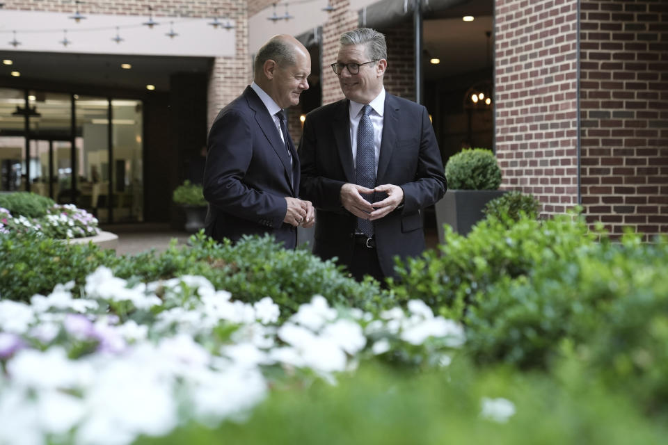 Britain's Prime Minister Keir Starmer, right, speaks with German Chancellor Olaf Scholz during a bilateral meeting at a hotel ahead of the NATO summit, in Washington, Wednesday July 10, 2024. (Stefan Rousseau/Pool Photo via AP)