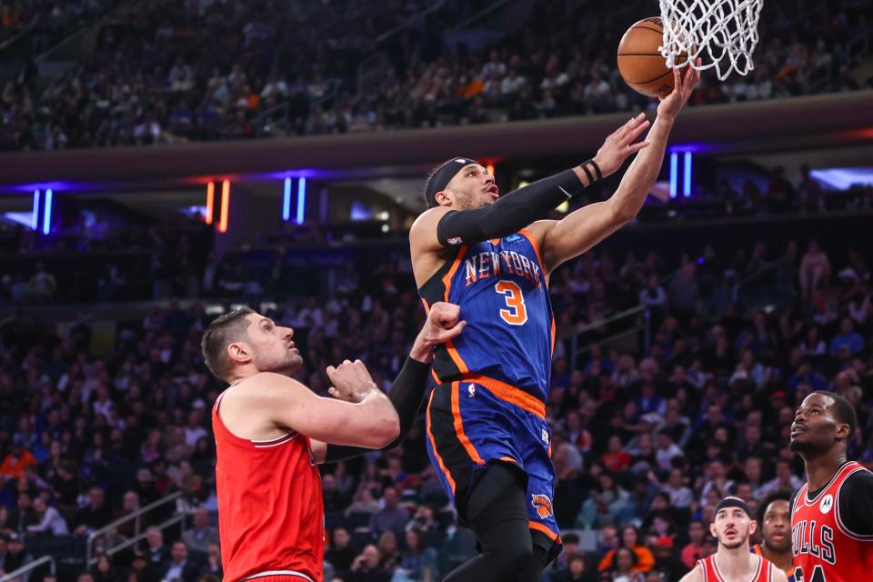 Apr 14, 2024; New York, New York, USA; New York Knicks guard Josh Hart (3) drives past Chicago Bulls center Nikola Vucevic (9) for a layup in the second quarter at Madison Square Garden. Mandatory Credit: Wendell Cruz-USA TODAY Sports